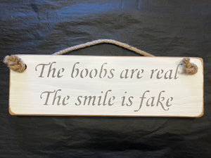 Wooden sign boobs real smile fake