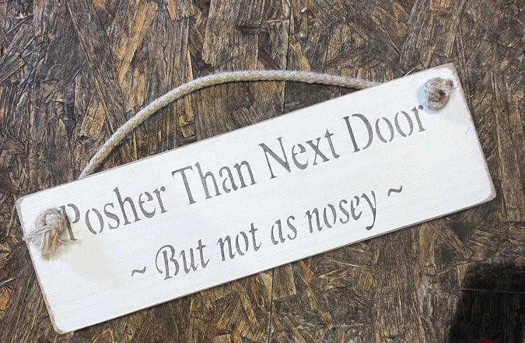 Wooden sign posher than next door