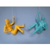 Blue and yellow climbing men sculptures